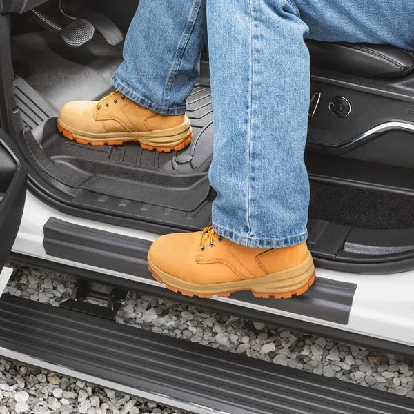 Person using a truck sill  protector with protective mat on a vehicle door