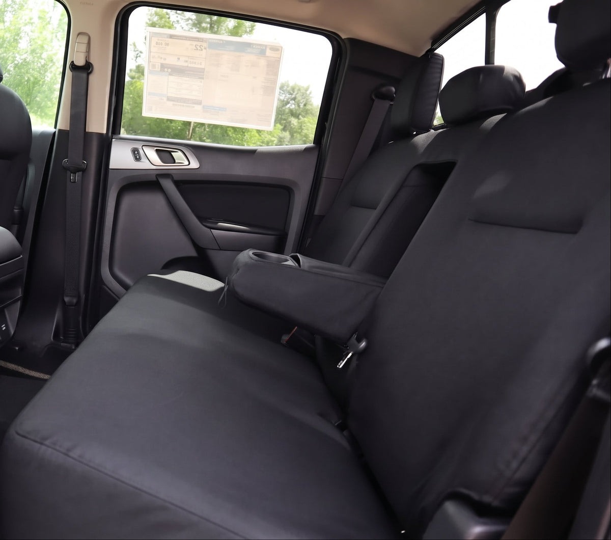 Black TigerTough Cordura interior rear seats of a Ford Ranger P703 Supercab, showing the spacious backseat area with center armrests and door panels