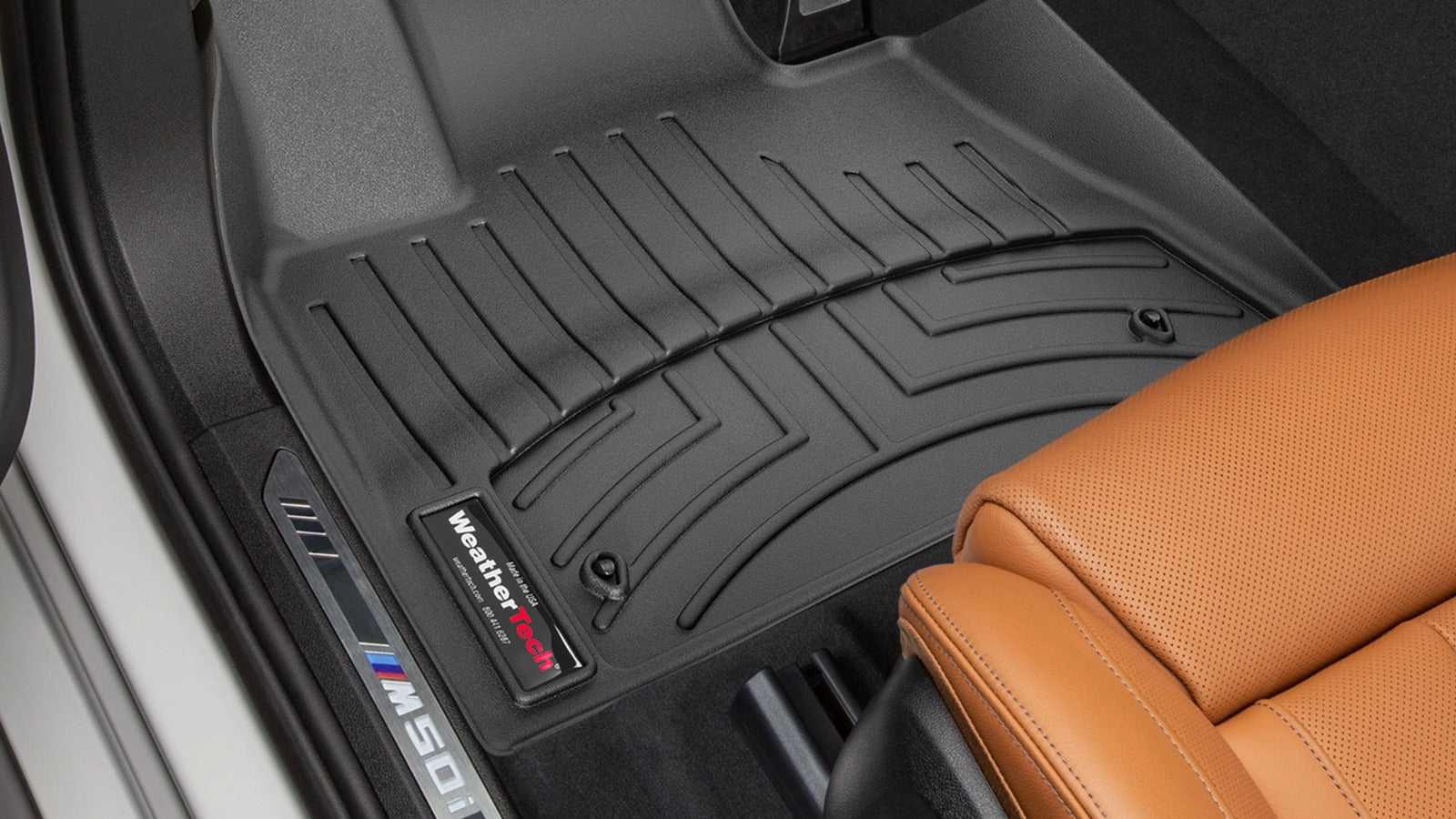 Black car floor mat with WeatherTech logo on a vehicle interior.