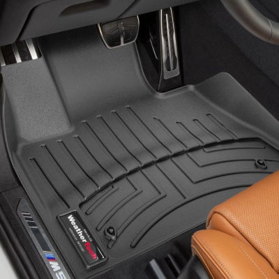 Black car floor mats with WeatherTech logo on a vehicle interior.